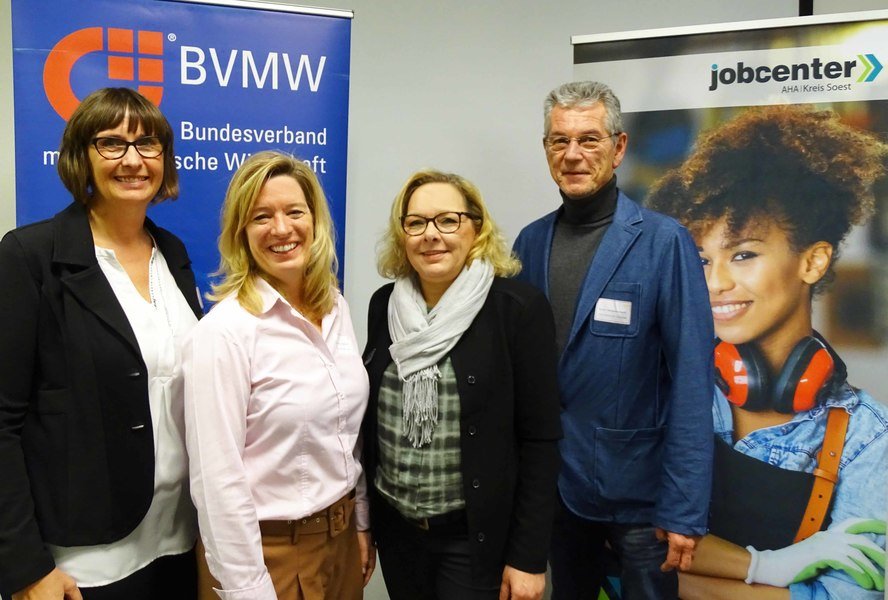 Vier Personen stehen vor zwei RollUps